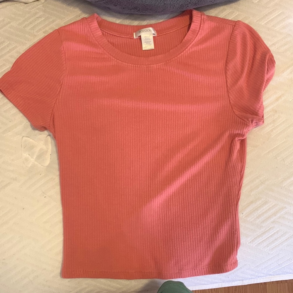 This shirt is a pink, kinda tight shirt but very comfortable and soft to wear.